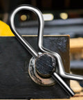 Close-up of a cotter pin from the 150 Pcs Cotter Pin Assortment Kit with R Shape Hitch Pin Clips installed on a metal hinge.