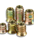 Close-up of six zinc-plated wood threaded inserts from 200-Piece Zinc Plated Wood Threaded Insert Kit With 1/4-20 And 5/16-18 Hex Drive Nut Inserts For Furniture Repair, DIY Woodworking, Nightstands, Beds, Cabinets And Home Office Projects.