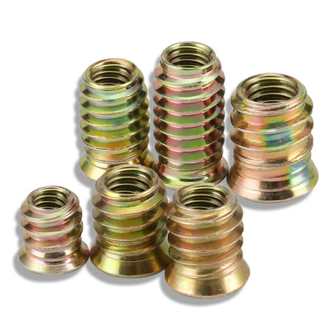 Close-up of six zinc-plated wood threaded inserts from 200-Piece Zinc Plated Wood Threaded Insert Kit With 1/4-20 And 5/16-18 Hex Drive Nut Inserts For Furniture Repair, DIY Woodworking, Nightstands, Beds, Cabinets And Home Office Projects.