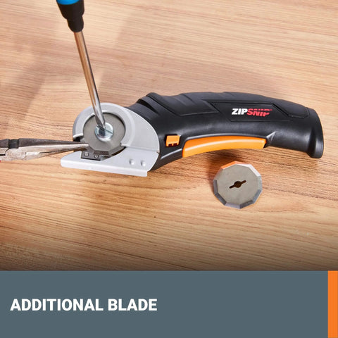 ZipSnip Cordless Electric Scissors 4V Box Cutter for Fabric shown with additional safety blade on a wood surface.