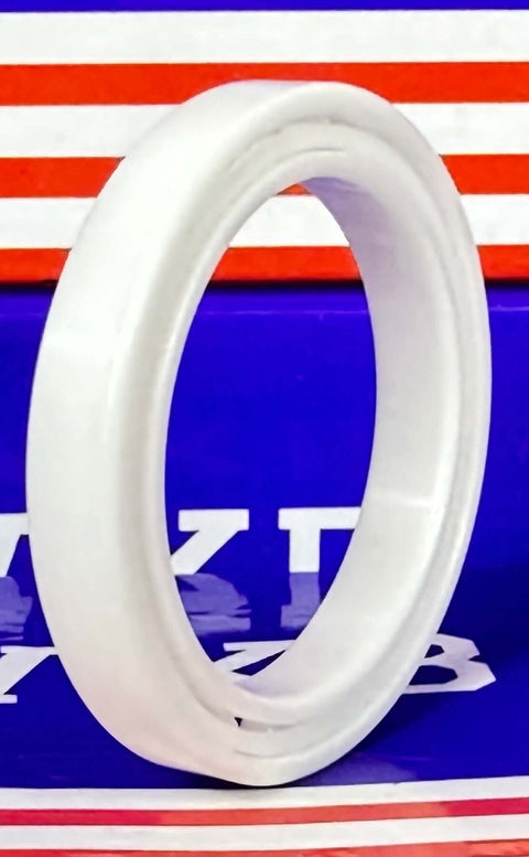 6807 Full Ceramic ZrO2 Bearing 35x47x7mm Metric side view of a white PTFE bearing ring against a colorful background.