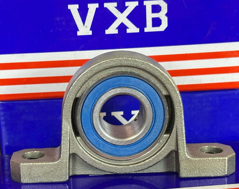 20mm Bore Miniature Stainless Steel Pillow Block Mounted Bearing on display with blue seal and silver housing.
