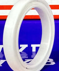 6807 Full Ceramic ZrO2 Bearing 35x47x7mm Metric side view of a white PTFE bearing ring against a colorful background.