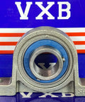 20mm Bore Miniature Stainless Steel Pillow Block Mounted Bearing on display against a blue background.