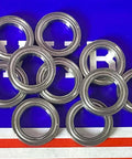 10-Pack 6701ZZ 12x18x4 Shielded 12mm Bore Diameter Bearing close-up view of bearings on a blue background.